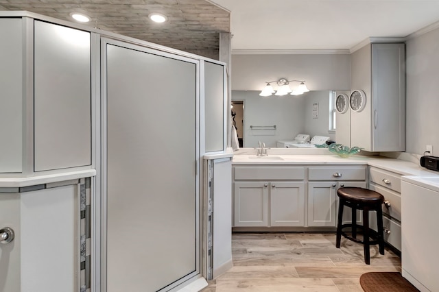 820 Meadow Ln, Wharton, TX 77488 - full bath with washer and dryer, a shower stall, vanity, wood finished floors, and ornamental molding