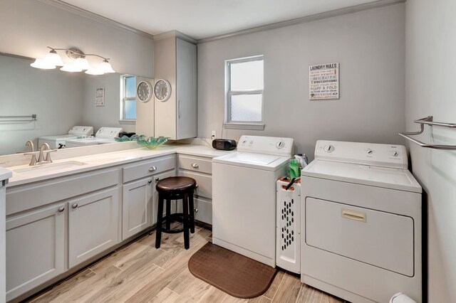 820 Meadow Ln, Wharton, TX 77488 - laundry room with washing machine and dryer, ornamental molding, and light wood-style flooring