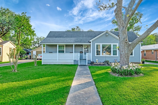 820 Meadow Ln, Wharton, TX 77488 - view of front of property with covered porch, a front yard, and roof with shingles
