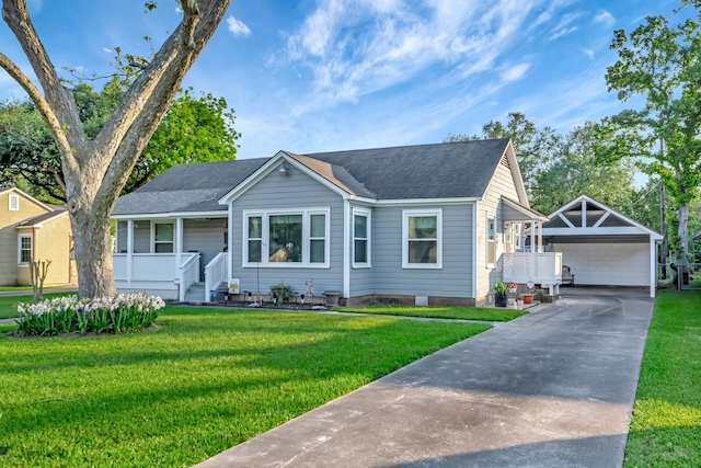 820 Meadow Ln, Wharton, TX 77488 - view of front of house featuring an outbuilding, covered porch, a front lawn, a shingled roof, and concrete driveway
