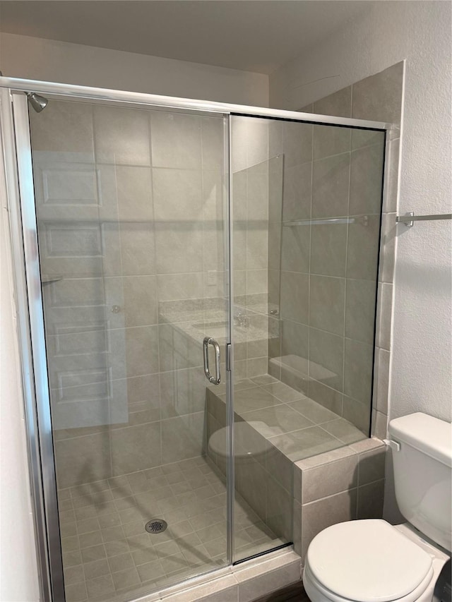 13305 Burbot Dr, Conroe, TX 77384 - bathroom featuring a stall shower and a textured wall