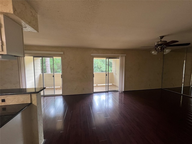 14515 Wunderlich Dr Unit 708, Houston, TX 77069 - unfurnished living room featuring dark wood-style floors, a ceiling fan, and a textured ceiling