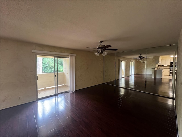 14515 Wunderlich Dr Unit 708, Houston, TX 77069 - unfurnished living room with dark wood-style flooring, a ceiling fan, a textured ceiling, and a textured wall