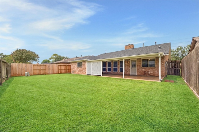 3114 Wagon Trail Dr, Sugar Land, TX 77479 - back of house with brick siding, a chimney, a fenced backyard, and a patio area