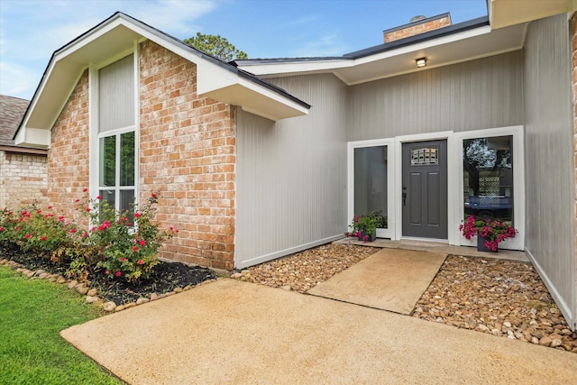 3114 Wagon Trail Dr, Sugar Land, TX 77479 - view of exterior entry with brick siding and a chimney