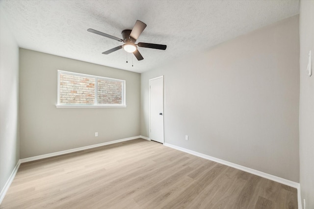 3114 Wagon Trail Dr, Sugar Land, TX 77479 - empty room with light wood finished floors, a ceiling fan, and a textured ceiling