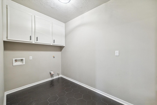 3114 Wagon Trail Dr, Sugar Land, TX 77479 - laundry room with hookup for a gas dryer, cabinet space, hookup for a washing machine, dark tile patterned floors, and a textured ceiling