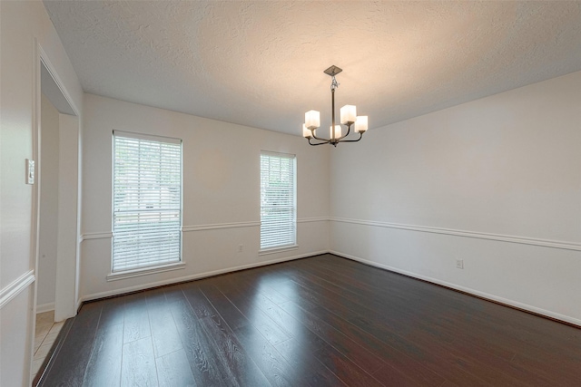 2510 Wind Fall Ln, Sugar Land, TX 77479 - empty room featuring a chandelier, hardwood / wood-style floors, and a textured ceiling