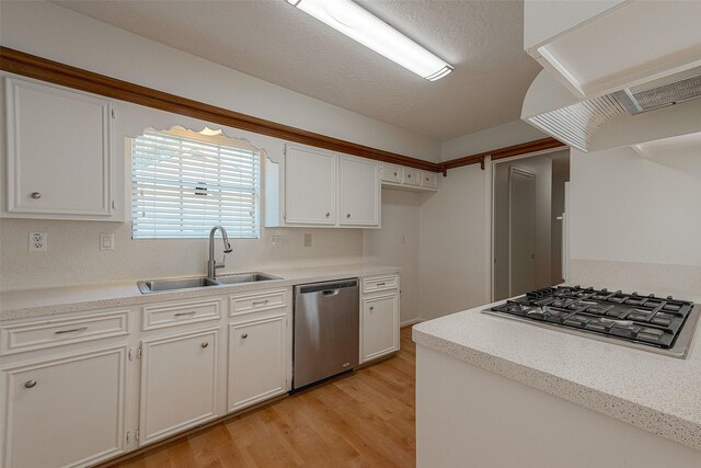 2510 Wind Fall Ln, Sugar Land, TX 77479 - kitchen featuring appliances with stainless steel finishes, extractor fan, light wood-style flooring, white cabinets, and light countertops