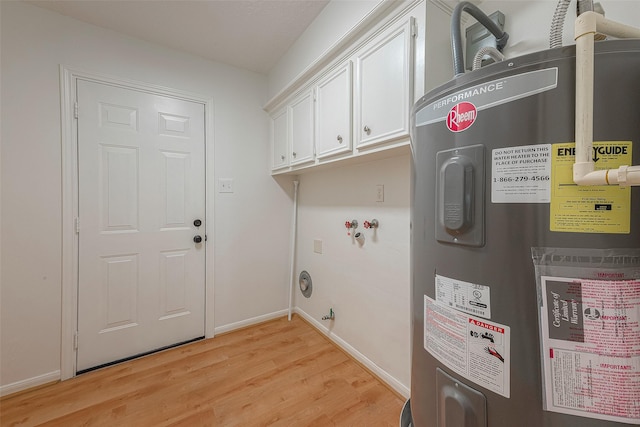 2510 Wind Fall Ln, Sugar Land, TX 77479 - laundry room with electric water heater, light wood-type flooring, gas dryer hookup, and cabinet space