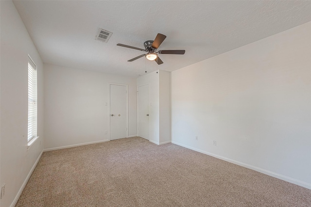 2510 Wind Fall Ln, Sugar Land, TX 77479 - unfurnished room with a ceiling fan, light colored carpet, and a textured ceiling