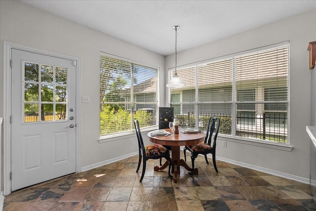 1427 Roaring Springs Ln, Seabrook, TX 77586 - dining area featuring dark stone finish floors and baseboards