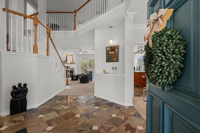 1427 Roaring Springs Ln, Seabrook, TX 77586 - entryway with stairway, stone finish floors, a ceiling fan, and a towering ceiling
