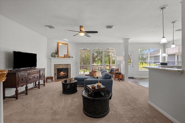1427 Roaring Springs Ln, Seabrook, TX 77586 - carpeted living area with a textured ceiling, ceiling fan, and a tile fireplace