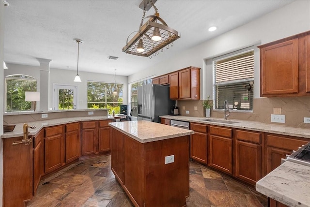 1427 Roaring Springs Ln, Seabrook, TX 77586 - kitchen featuring appliances with stainless steel finishes, stone tile flooring, a kitchen island, backsplash, and recessed lighting