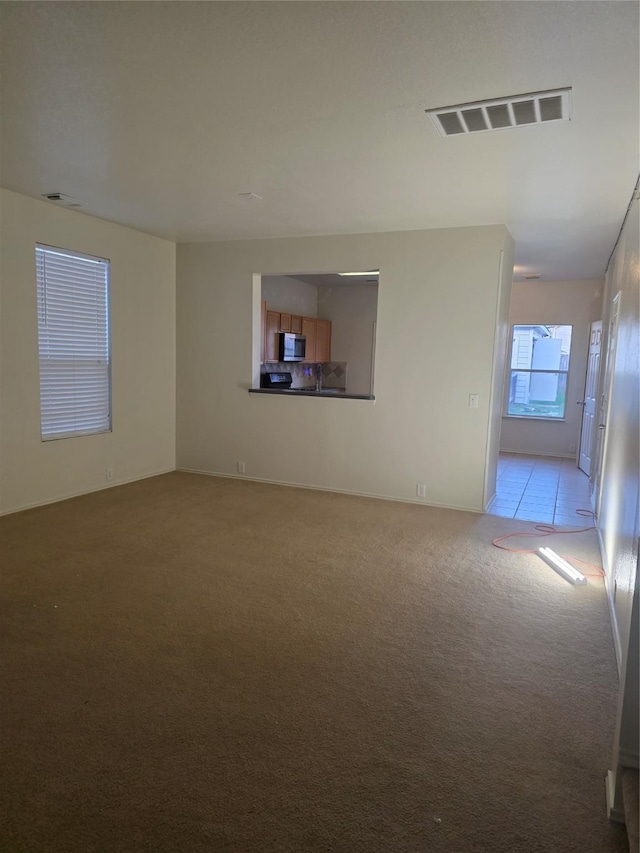 9714 Coyote Creek Dr, Houston, TX 77095 - empty room featuring light carpet and baseboards