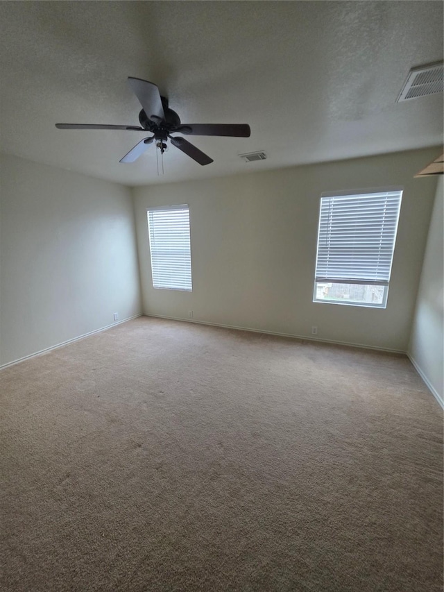 9714 Coyote Creek Dr, Houston, TX 77095 - carpeted spare room featuring a ceiling fan and a textured ceiling