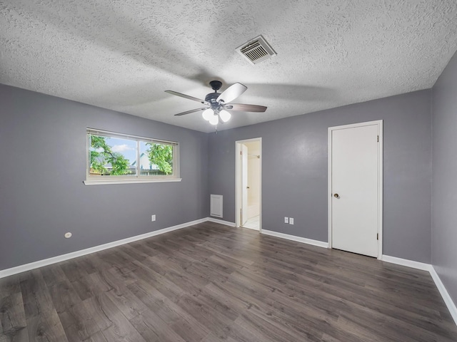 1406 Chippawa Ln, Pasadena, TX 77504 - unfurnished bedroom featuring dark wood-style floors, a textured ceiling, connected bathroom, and ceiling fan