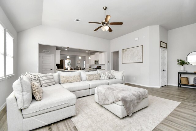 8419 Sunset Horizon Dr, Baytown, TX 77521 - living area with light wood-style flooring, a ceiling fan, and vaulted ceiling