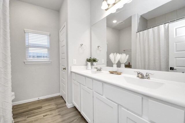 8419 Sunset Horizon Dr, Baytown, TX 77521 - full bathroom with double vanity and wood finished floors