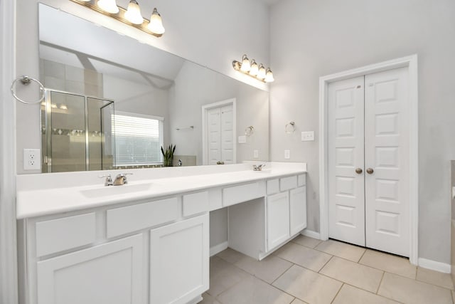 8419 Sunset Horizon Dr, Baytown, TX 77521 - bathroom featuring double vanity, a stall shower, tile patterned floors, a closet, and lofted ceiling