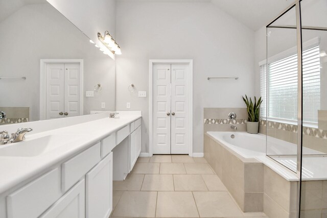 8419 Sunset Horizon Dr, Baytown, TX 77521 - full bath featuring double vanity, a bath, tile patterned floors, high vaulted ceiling, and a closet