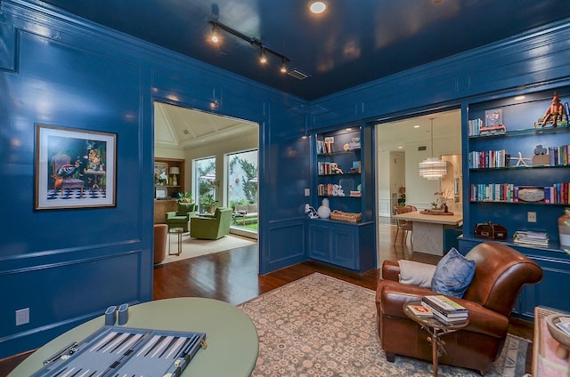 987 S Post Oak Ln, Houston, TX 77056 - living area featuring crown molding, dark wood finished floors, and built in shelves