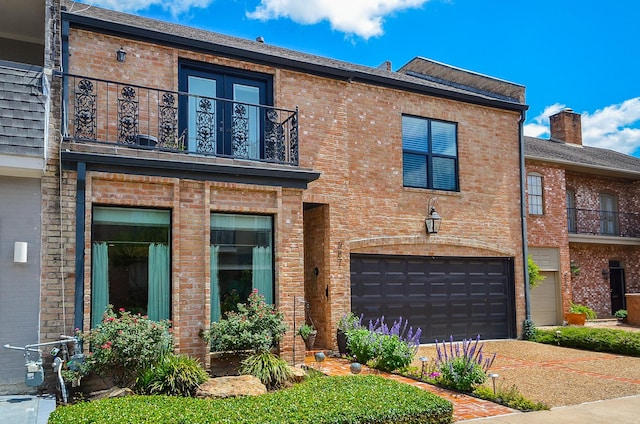987 S Post Oak Ln, Houston, TX 77056 - view of front facade with a balcony, brick siding, a garage, and driveway