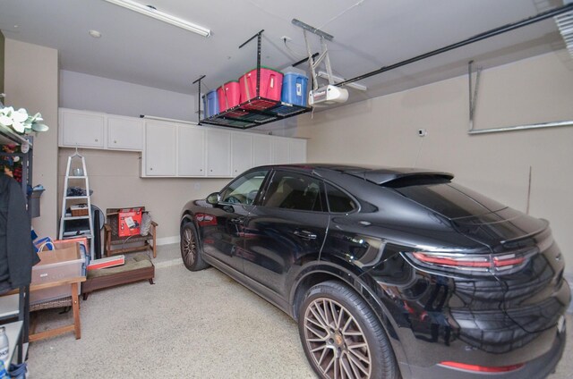 987 S Post Oak Ln, Houston, TX 77056 - garage with a garage door opener and baseboards