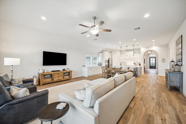 1523 Carson Field Ln, Richmond, TX 77469 - living area featuring arched walkways, ceiling fan, light wood-style floors, and recessed lighting