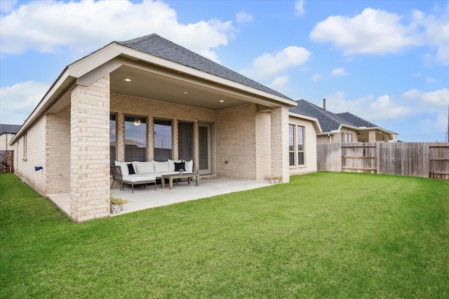 1523 Carson Field Ln, Richmond, TX 77469 - back of property featuring brick siding, a patio, a fenced backyard, an outdoor hangout area, and a shingled roof