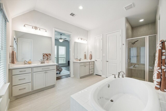 1523 Carson Field Ln, Richmond, TX 77469 - bathroom featuring a stall shower, a garden tub, two vanities, a ceiling fan, and lofted ceiling