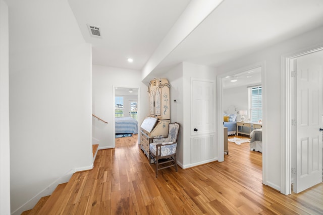 710 93rd St, Galveston, TX 77554 - hallway featuring light wood-style flooring, baseboards, stairway, and recessed lighting