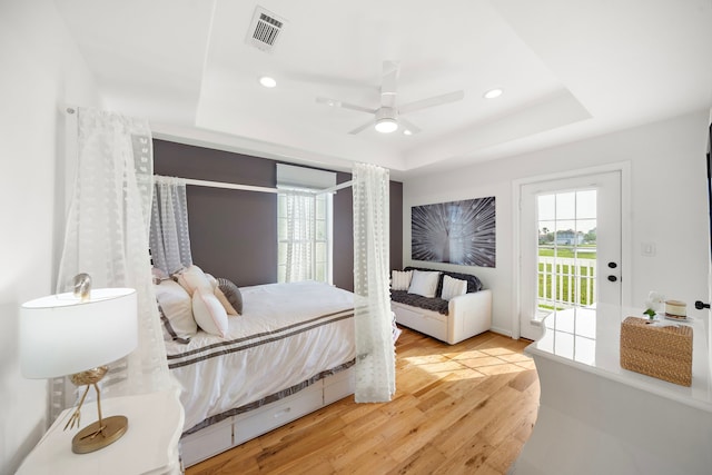 710 93rd St, Galveston, TX 77554 - bedroom with a raised ceiling, access to outside, wood finished floors, recessed lighting, and ceiling fan