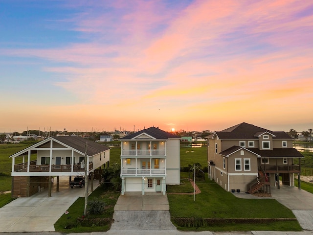 710 93rd St, Galveston, TX 77554 - view of front facade featuring concrete driveway, a balcony, and a residential view