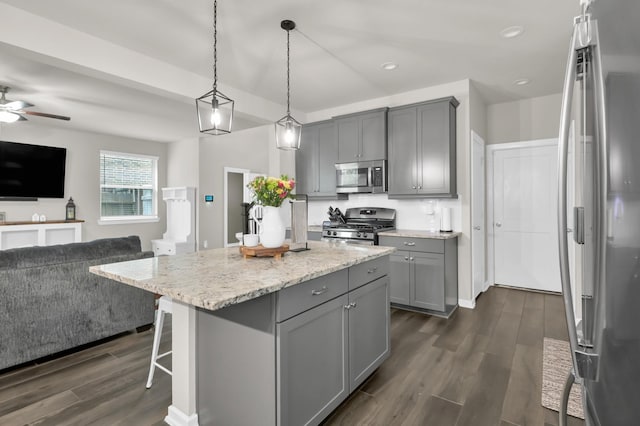 12330 Castano Creek Dr, Humble, TX 77346 - kitchen featuring stainless steel appliances, gray cabinetry, open floor plan, dark wood finished floors, and recessed lighting