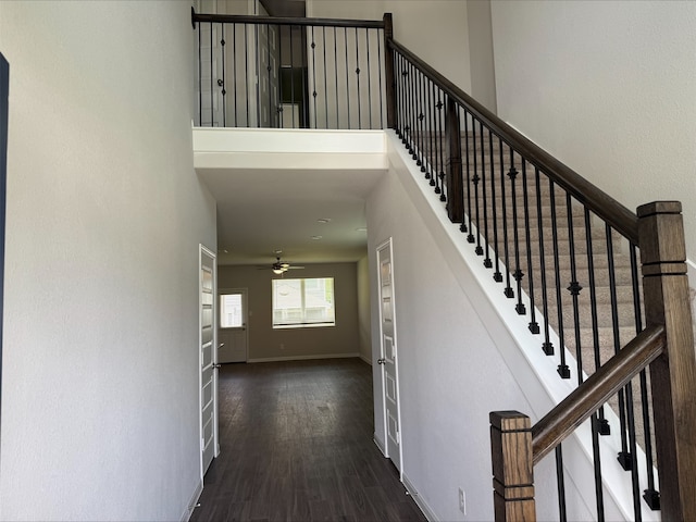 13308 Burbot Dr, Conroe, TX 77384 - stairs with wood finished floors, ceiling fan, and a towering ceiling