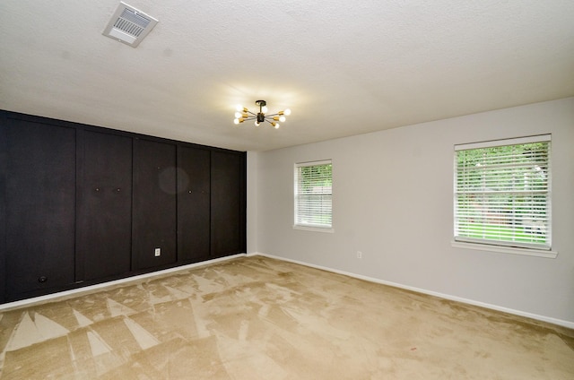 9719 Kindletree Dr, Houston, TX 77040 - unfurnished bedroom featuring a chandelier and light carpet