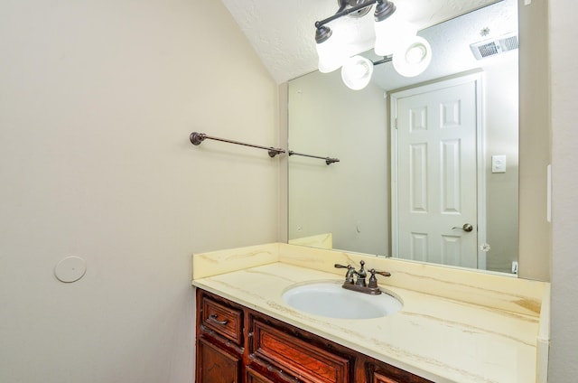 9719 Kindletree Dr, Houston, TX 77040 - bathroom with vanity, vaulted ceiling, and a textured ceiling