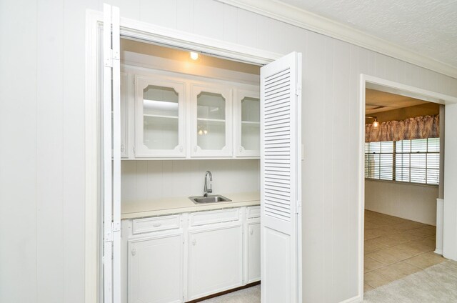 9719 Kindletree Dr, Houston, TX 77040 - bar area featuring ornamental molding and light tile patterned floors