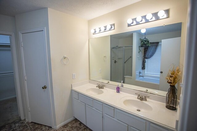 20422 Linden Tree Dr, Katy, TX 77449 - bathroom featuring a stall shower, a bath, double vanity, a textured ceiling, and a spacious closet
