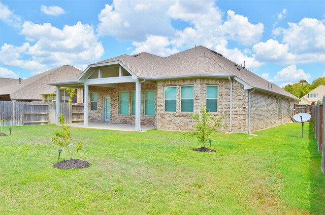 9323 Stablewood Lakes Ln, Tomball, TX 77375 - rear view of house featuring brick siding, a fenced backyard, a patio area, and a shingled roof