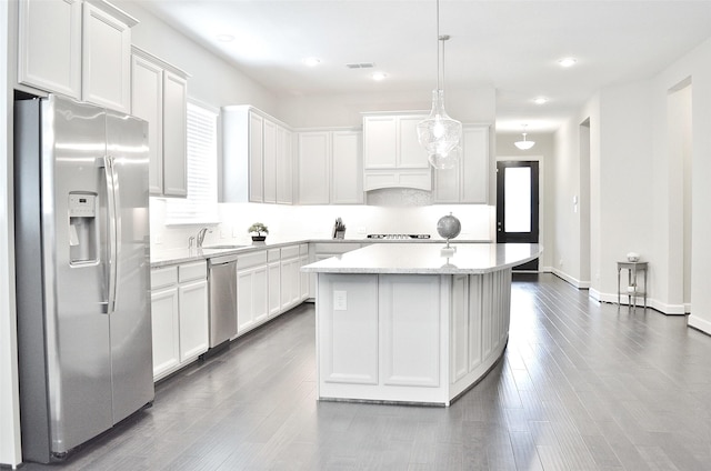 9323 Stablewood Lakes Ln, Tomball, TX 77375 - kitchen with stainless steel appliances, light countertops, a center island, white cabinetry, and recessed lighting