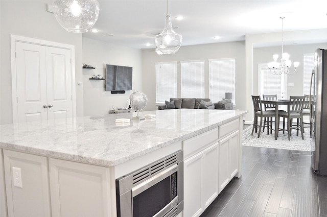 9323 Stablewood Lakes Ln, Tomball, TX 77375 - kitchen with appliances with stainless steel finishes, a chandelier, white cabinetry, light stone countertops, and recessed lighting