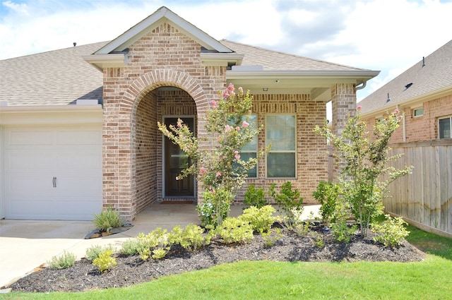 9323 Stablewood Lakes Ln, Tomball, TX 77375 - view of front of house featuring brick siding, an attached garage, a shingled roof, and driveway