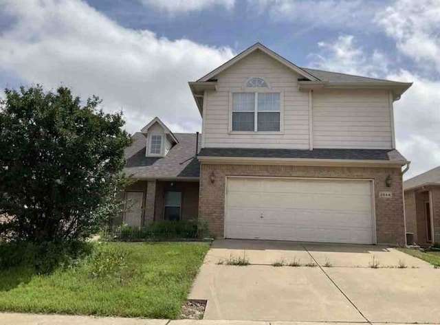 2694 Bull Shoals Dr, Fort Worth, TX 76131 - view of front of property with driveway, an attached garage, and brick siding