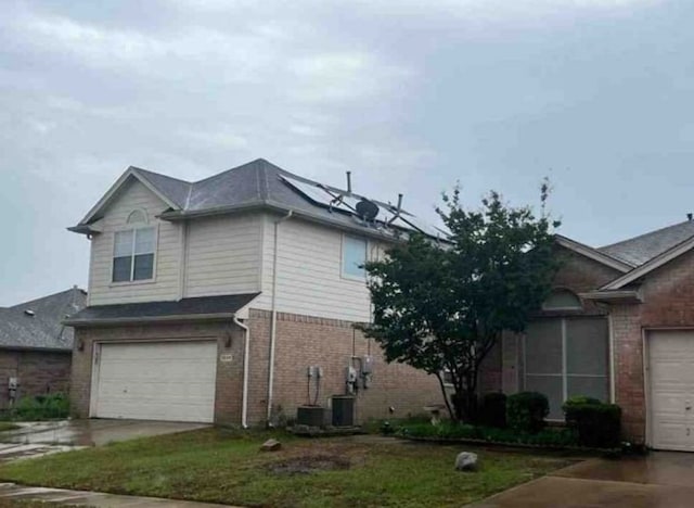 2694 Bull Shoals Dr, Fort Worth, TX 76131 - view of side of home with brick siding, concrete driveway, and a garage