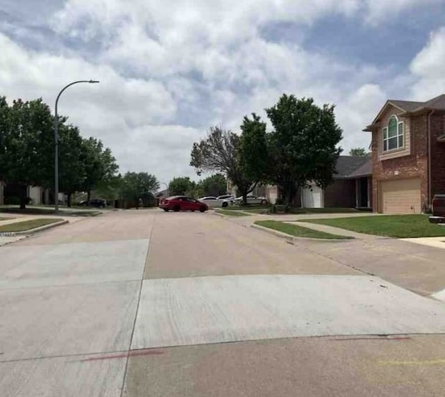 2694 Bull Shoals Dr, Fort Worth, TX 76131 - view of concrete road with sidewalks, street lighting, and curbs