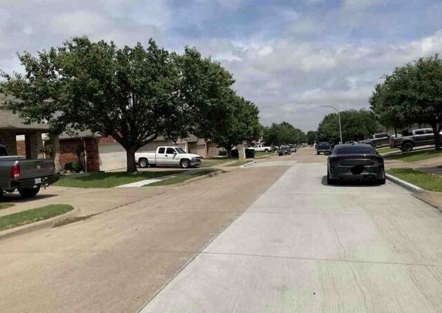 2694 Bull Shoals Dr, Fort Worth, TX 76131 - view of concrete road featuring curbs, sidewalks, and street lights