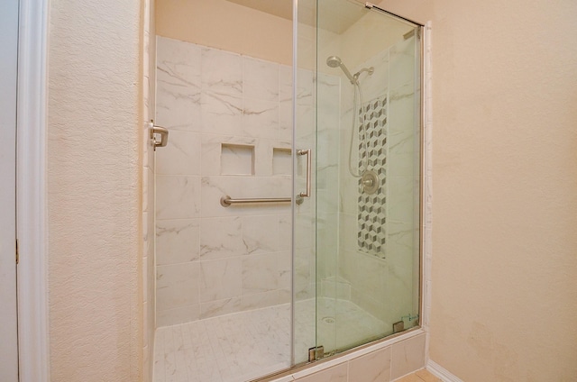 19038 Winding Stream Ln, Houston, TX 77084 - bathroom featuring a stall shower and a textured wall